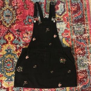 Black denim overalls with floral detail